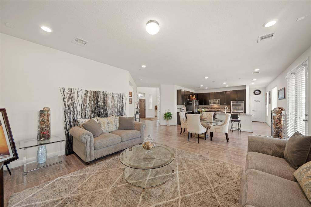 An open-concept living area with plenty of space and a seamless flow into the modern kitchen is perfect for family gatherings and entertaining.