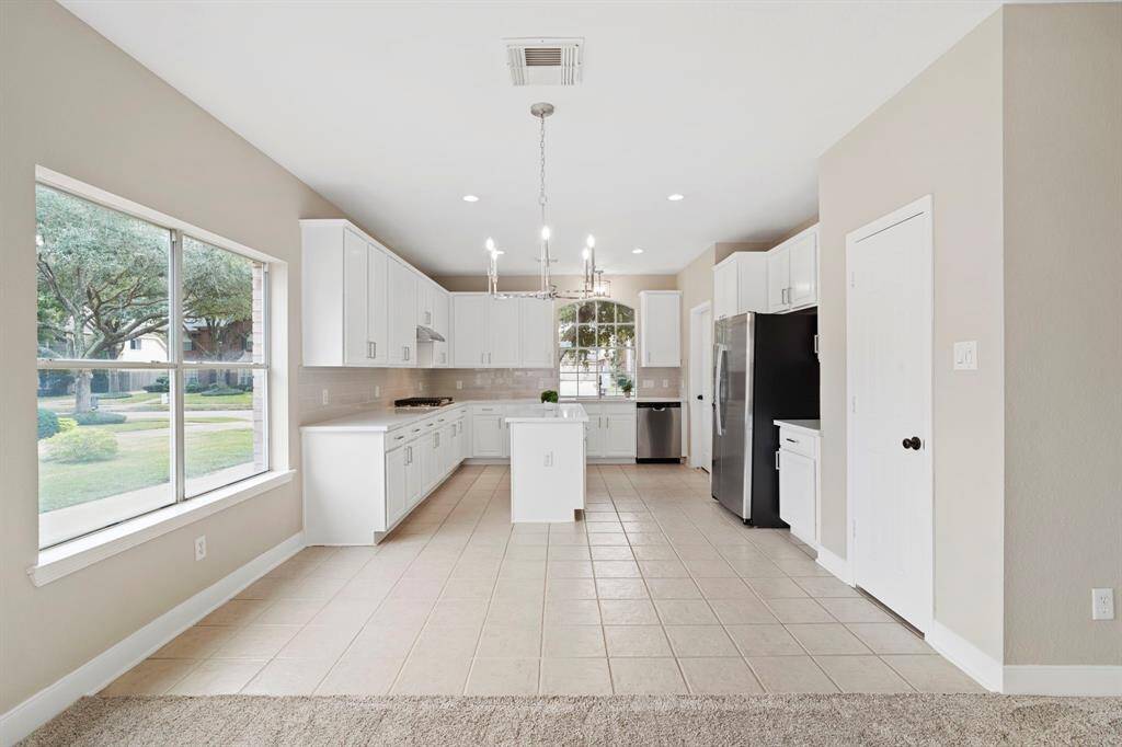 The kitchen, an integral part ofthis home's open-conceptdesign, seamlessly flows off theliving room, creating aharmonious and connectedliving space.