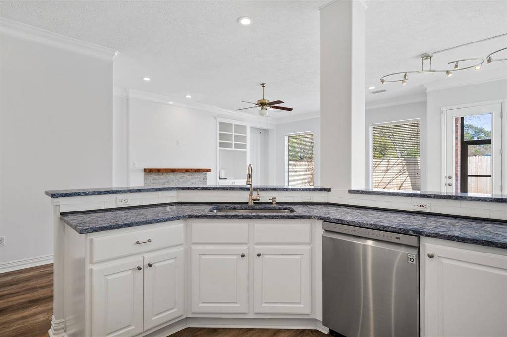 View of sink, dishwasher and countertops.