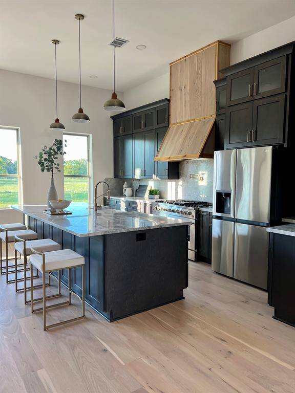 The space is bright and airy with natural light from multiple windows, offering a stylish and functional design.