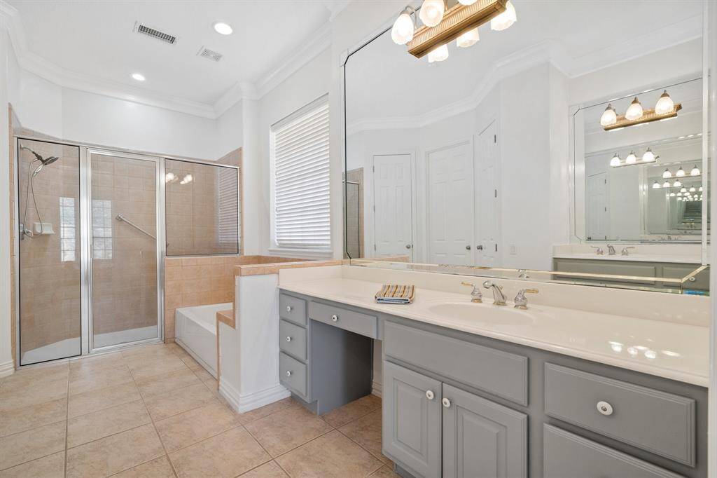 Primary bath with  dressing table space, separate shower & toilet, and spacious walk in closet.