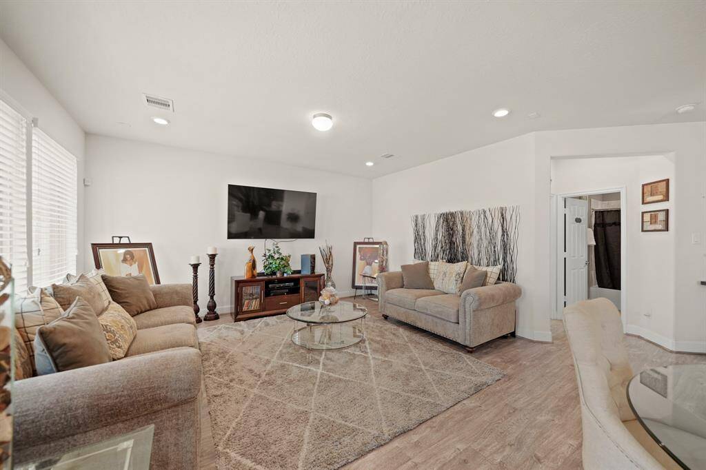 This spacious living room is conveniently located close to the guest bedroom and full bathroom on the first floor.