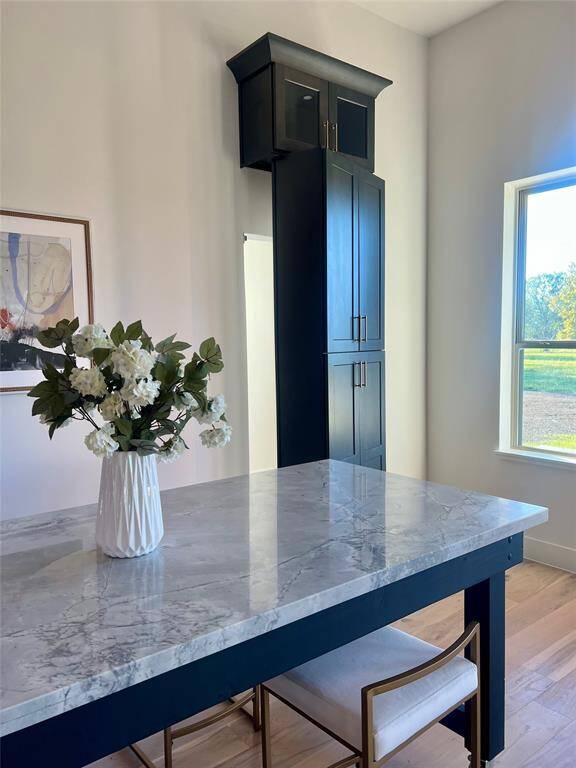 Elegance continues through the kitchen into the breakfast area featuring a custom versatile quartz table.