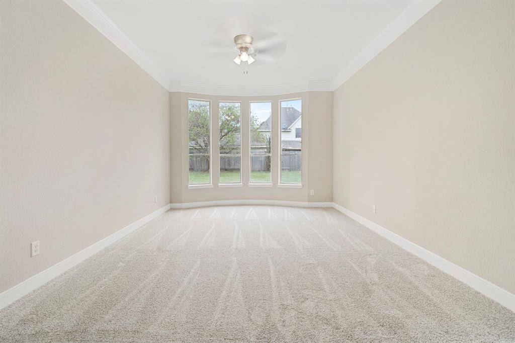 This dining room has plushcarpet and is bathed in naturallight streaming throughexpansive windows.