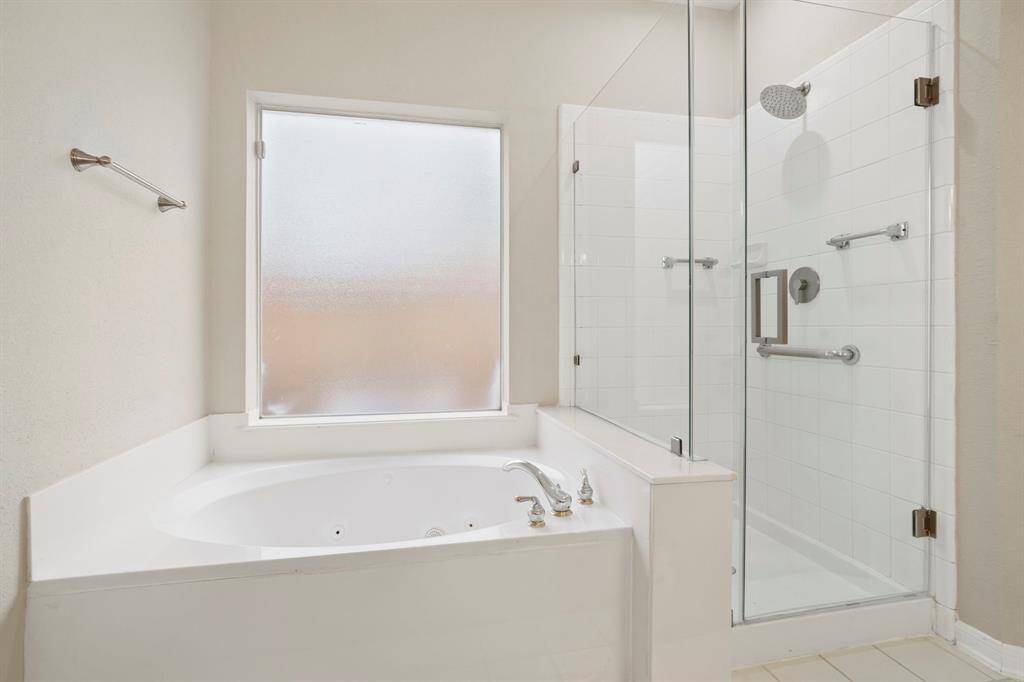 The walk-in shower is frameless and the separate jetted tub is great for soaking after a long day.