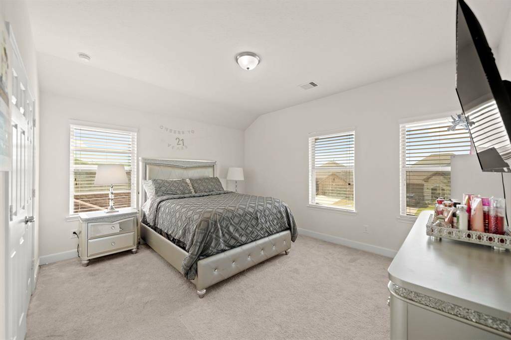4th bedroom upstairs... The spacious bedroom with large windows and plush carpeting offers a bright and comfortable retreat.