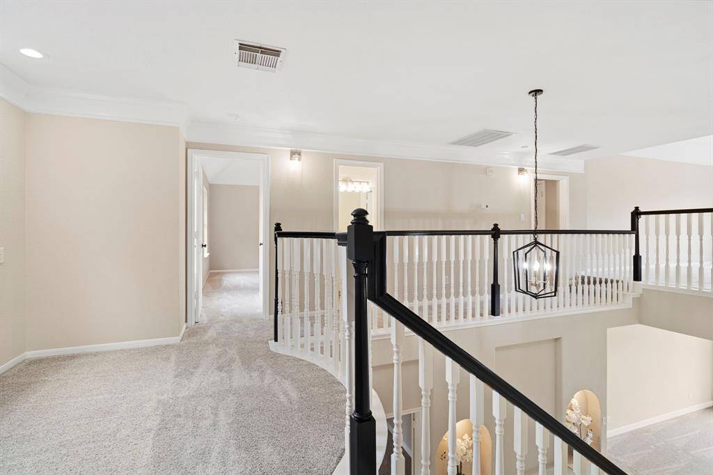 The chandelier hangs over the welcoming entryway foyer.