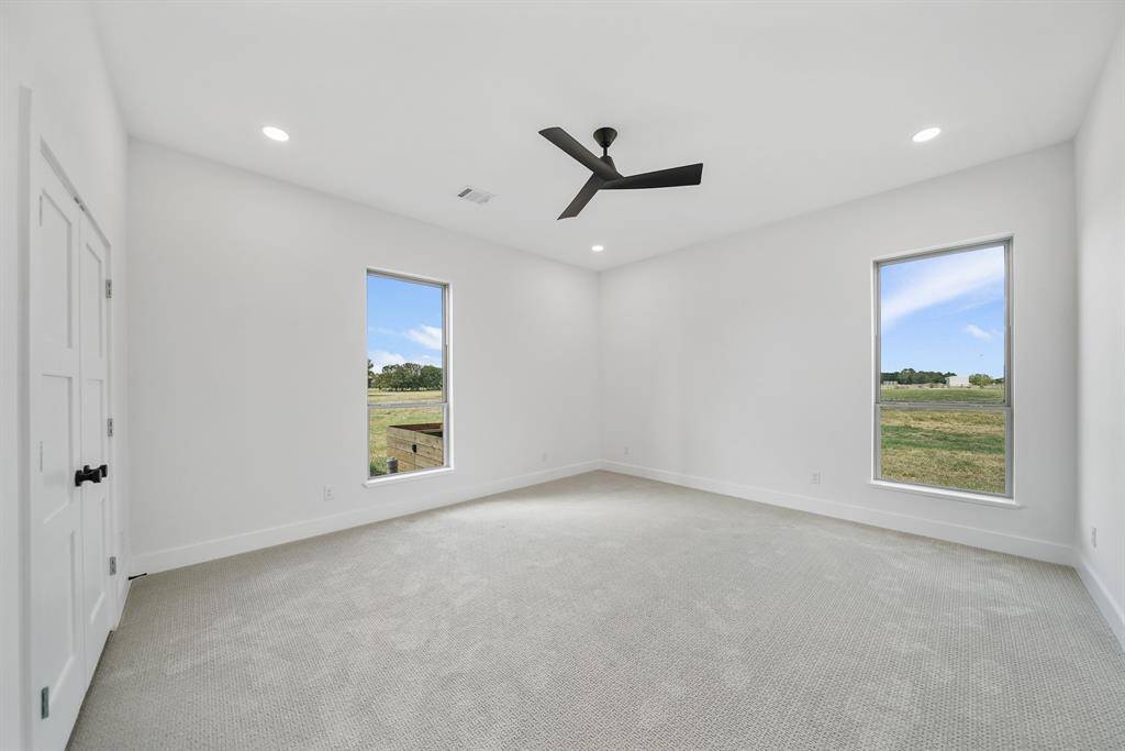 Secondary bedroom downstairs offers two large windows offering scenic views.