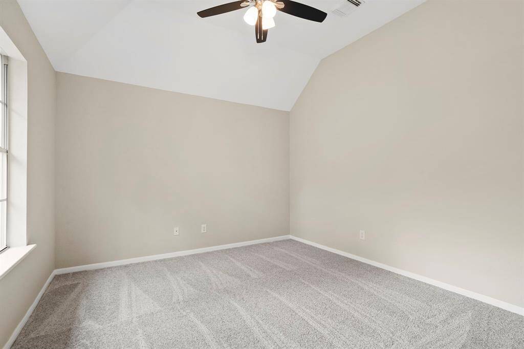 Third bedroom features windows, plush new carpet, and a ceiling fan.