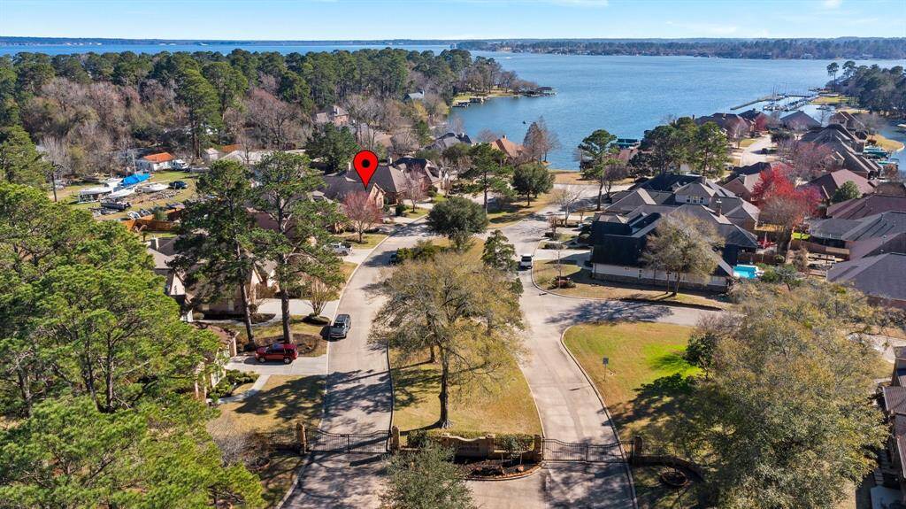 Aerial view of Hunters Landing Neighborhood, with view of Lake Conroe. Notice red marker indicating location of 1123 Looking Glass Blvd.