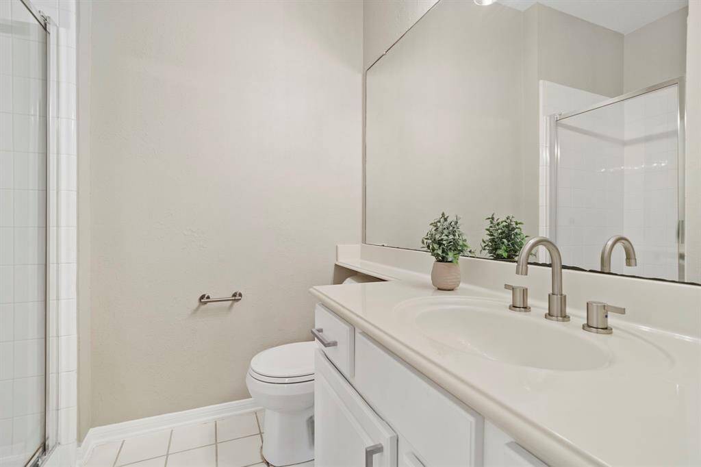 Fourth bathroom features tile floors and a walk-in shower.