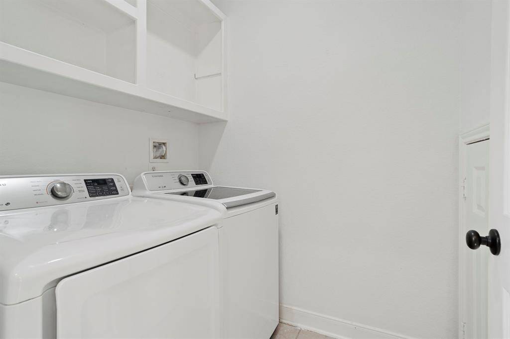 The laundry room features tilefloors, washer and dryerconnections, andplenty of storage space.