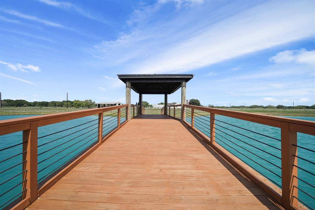 Gazebo and bridge over the large stocked pond. Perfect for enjoying peaceful waterfront views.