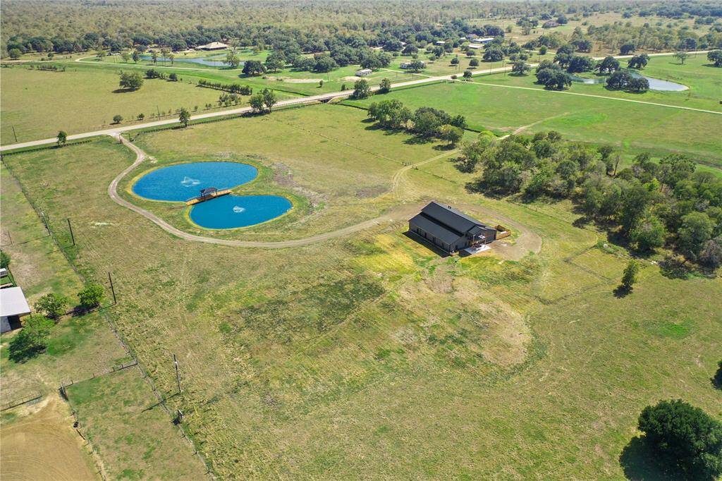 This aerial photo showcases your new spacious rural property. The land provides a picturesque and private setting.