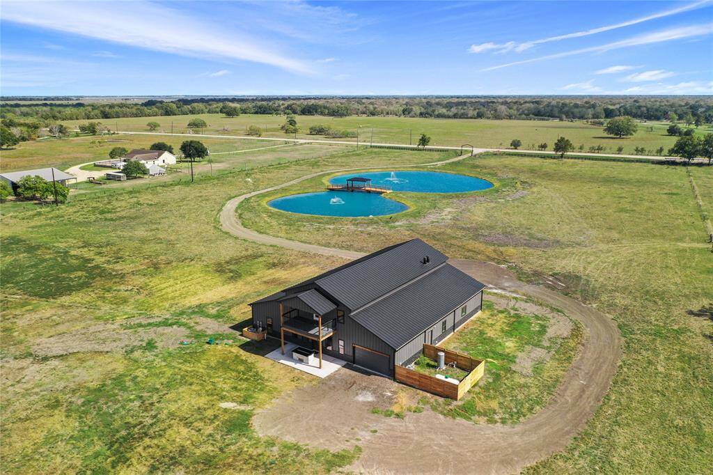 Large surrounding yard and a circular driveway. A scenic pond with a fountains enhancing the rural, peaceful setting.