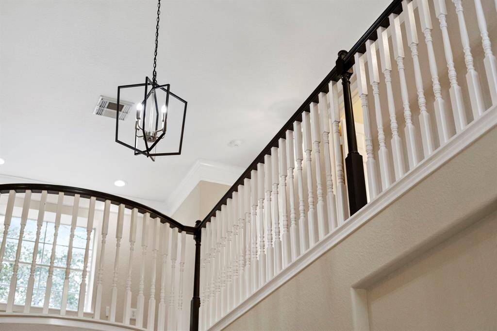 The chandelier lights the entryway.