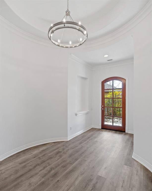 Wide open foyer area with niche and new light
