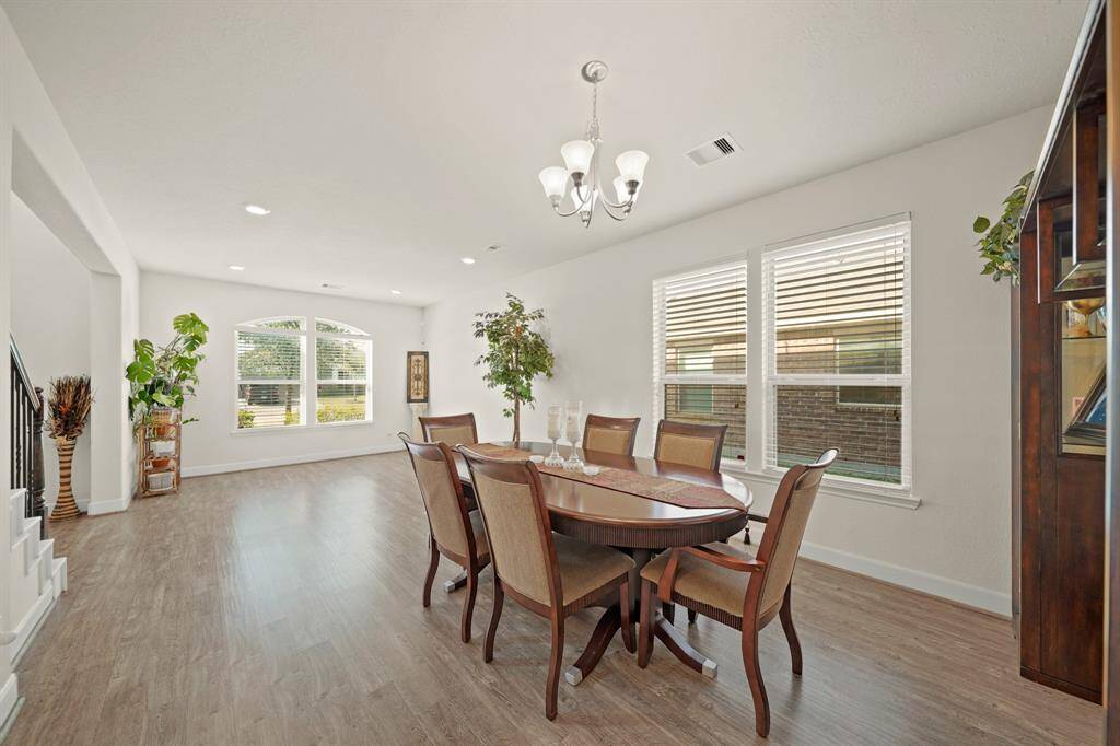 A view of the formal Dining and formal living room with natural sunlight.