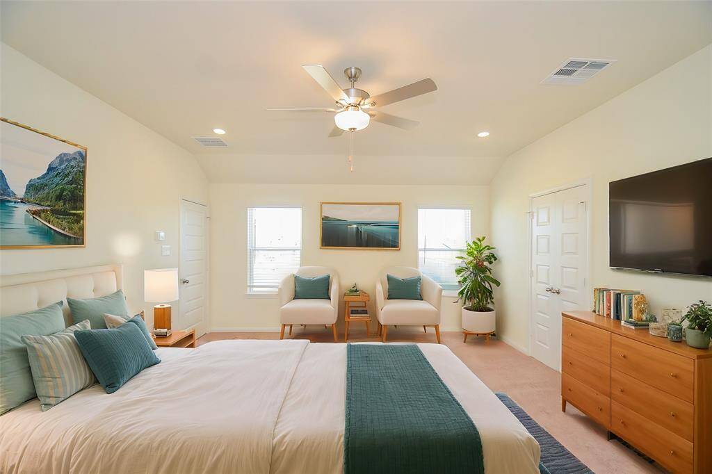 Step into this generously sized bedroom that offers a tranquil retreat with abundant natural light.