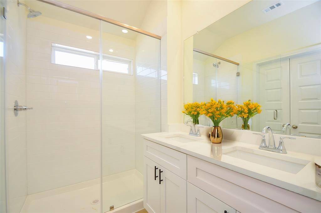 This beautifully appointed bathroom offers a sleek and modern design.