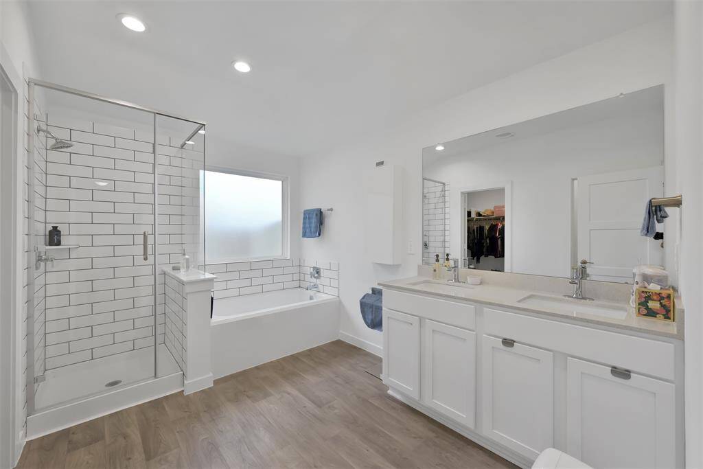 Primary bath, dual vanities, soaking tub and shower.
