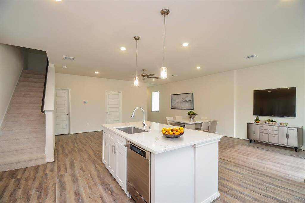 Recessed lighting illuminates the area, creating a bright and inviting atmosphere.