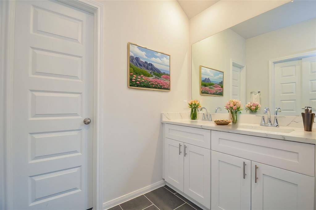 Notice the sleek double vanity with its contemporary fixtures and ample countertop space.