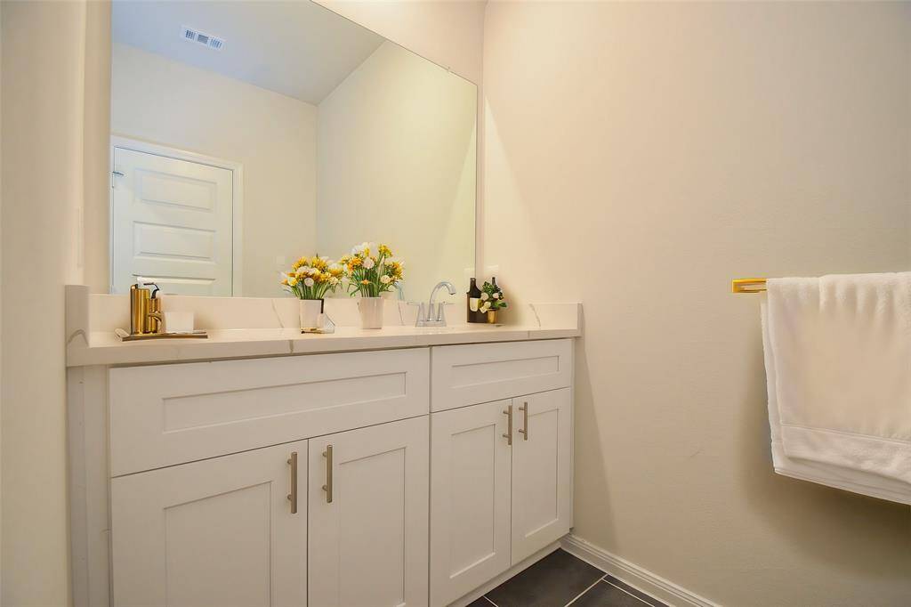 This bathroom features ample counter space for storage and beautiful cabinetry.