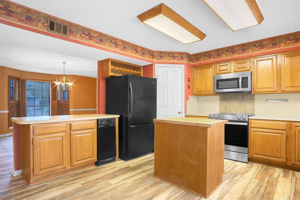 Additional view of the kitchen opening to the formal dining room. Refrigerator to stay!!!