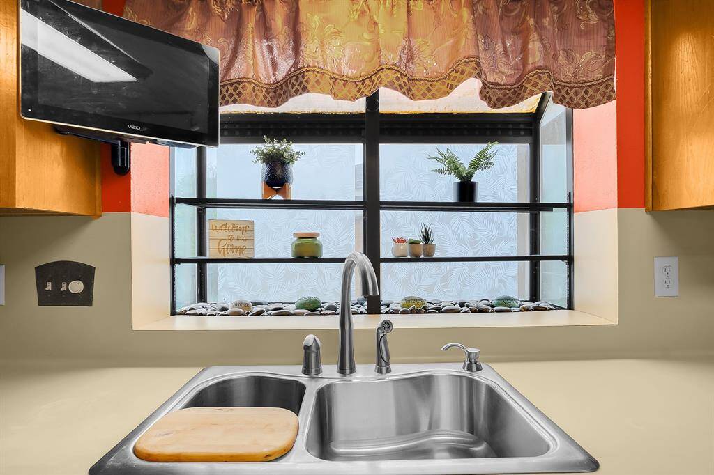The bay window makes growing fresh herbs a breeze, bringing both convenience and charm to the kitchen while offering lovely views of the backyard.