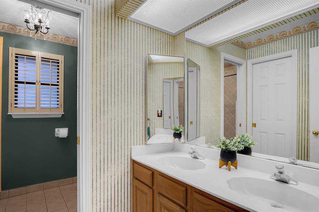 The secondary bathroom is located upstairs and features a double vanity, ample storage and recently remodeled shower/tub combo!