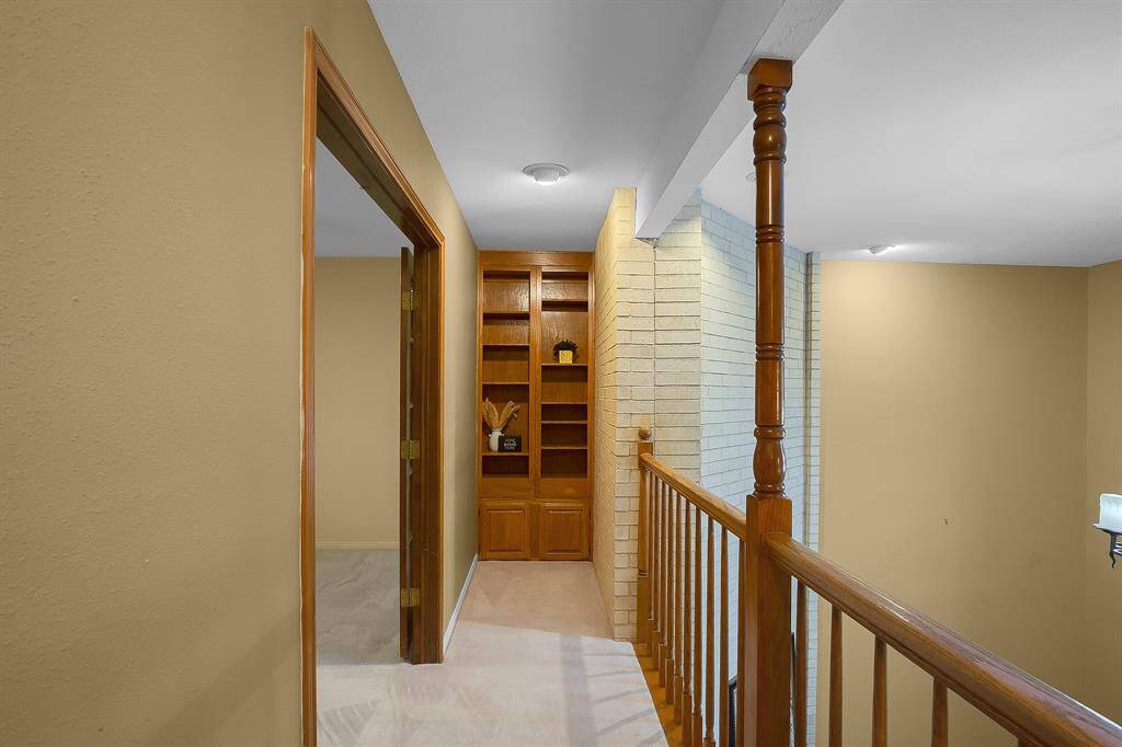 Built-in bookshelves at the end of the upstairs hallway provide the perfect spot to showcase your decor, adding both style and functionality to the space.