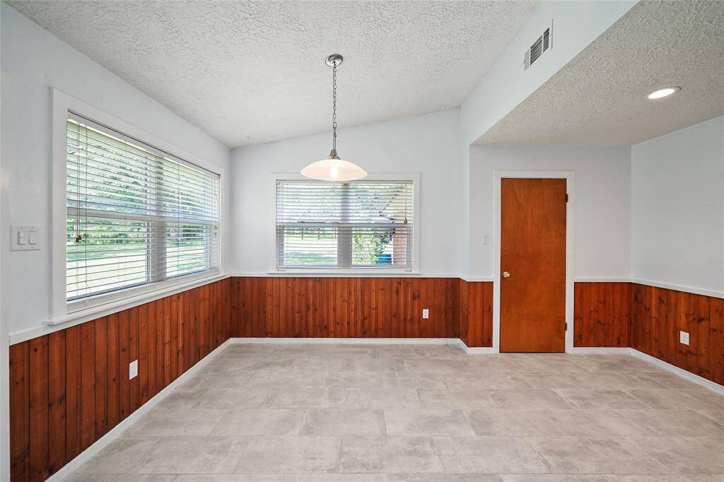 Dining area with tons of space and natural lighting, perfect for family dinners.
