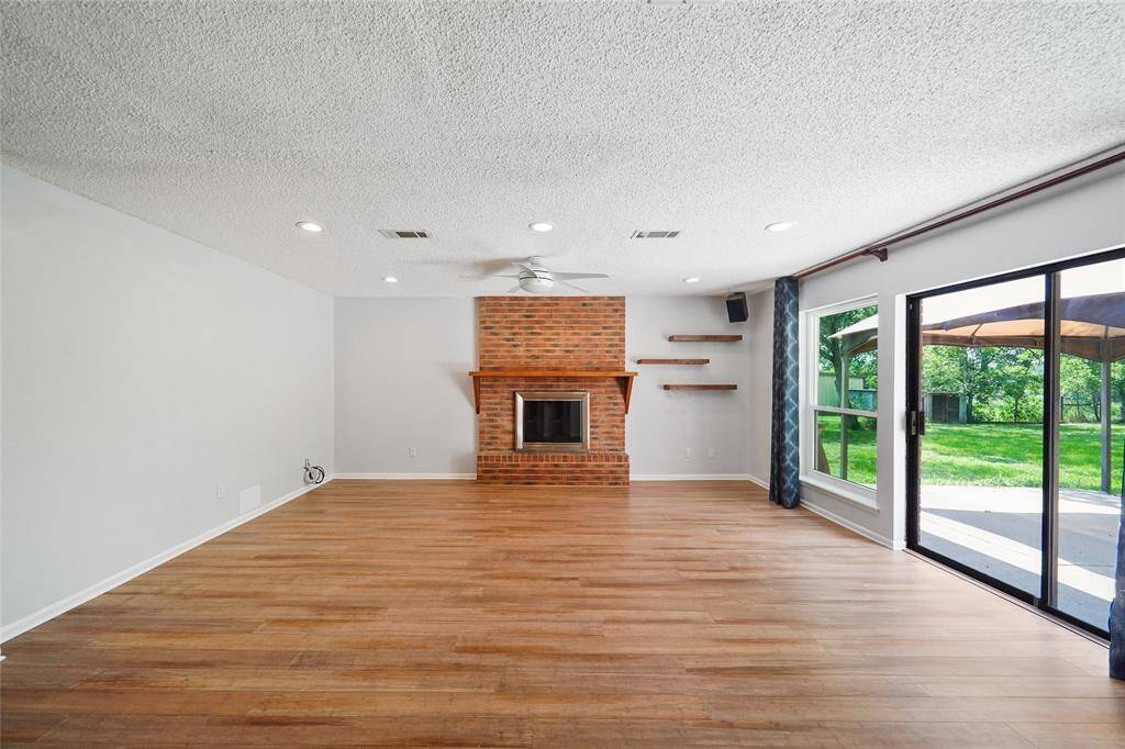 Classic brick fireplace with charming shelf for decor or a television.