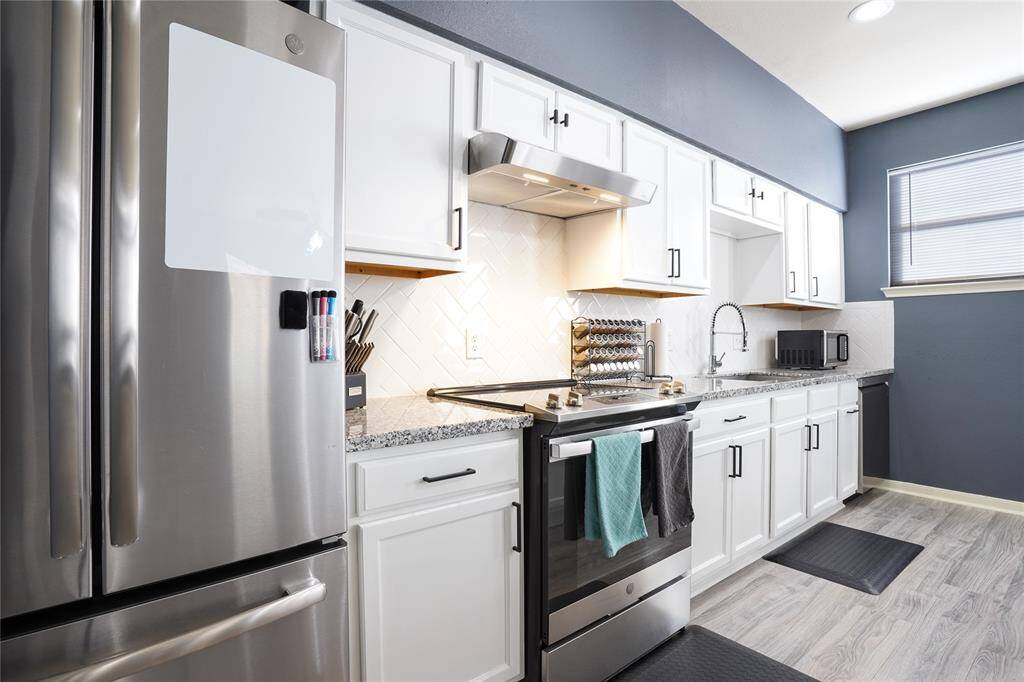 Unit B - Stainless steel appliances (electric stove).