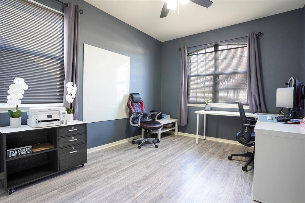 Unit B - Downstairs bedroom with large windows facing the front of the home (Room does not have the white board).