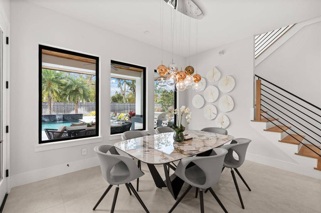 Adjacent to the kitchen, the cozy Breakfast Area offers a casual dining space with a beautiful view of the sparkling pool and spa, creating the perfect spot to relax and enjoy your meals.