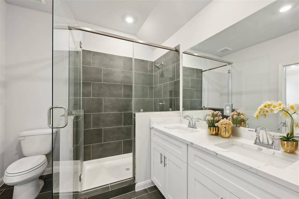 Experience a contemporary walk-in shower featuring glass walls and elegant tile designs, which will bring a spa-like ambiance to your home.