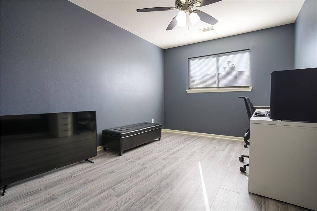 Unit B - Spacious upstairs bedroom 2 with laminate flooring.
