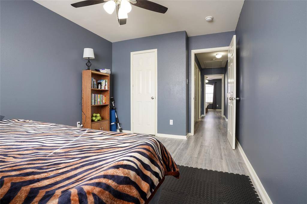 Unit B - Bedroom 3 has walk-in closet, ceiling fan, and large window with blinds.
