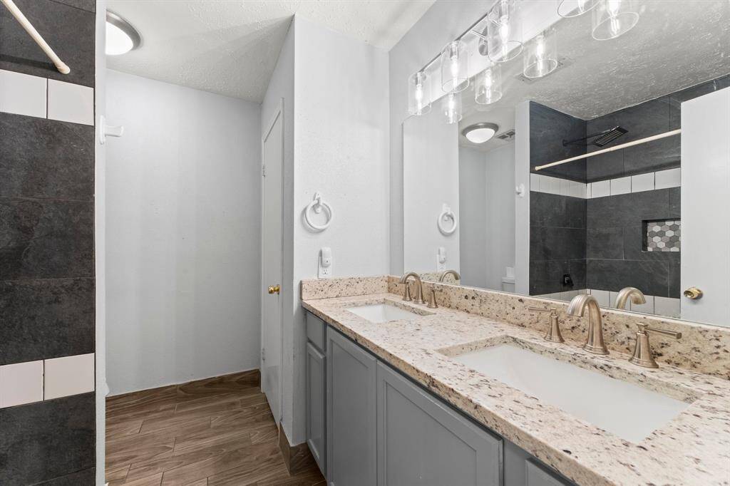 Secondary bathroom with double vanities.