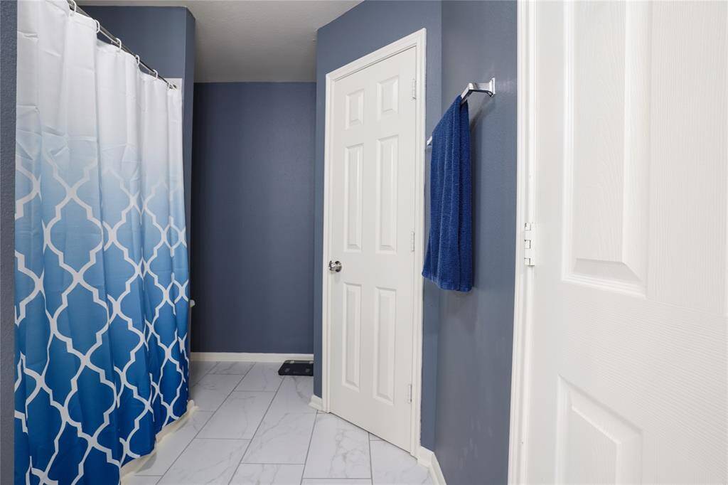 Unit B - Shower/tub combo on the left, linen closet towards the back, and right back door to toilet.