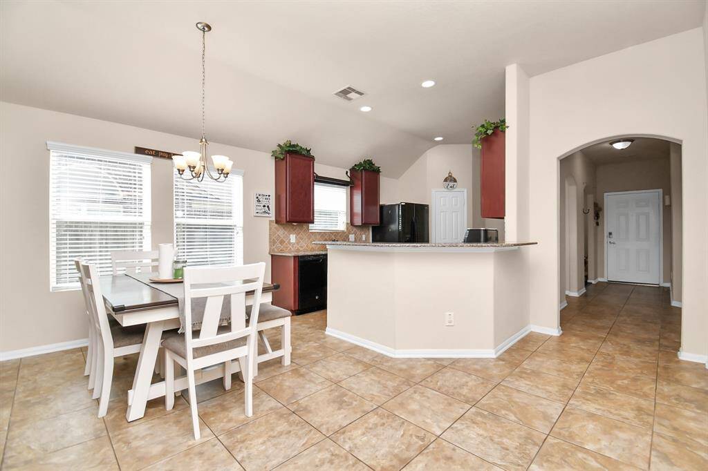 The kitchen flows seamlessly into the inviting dining and family areas.
