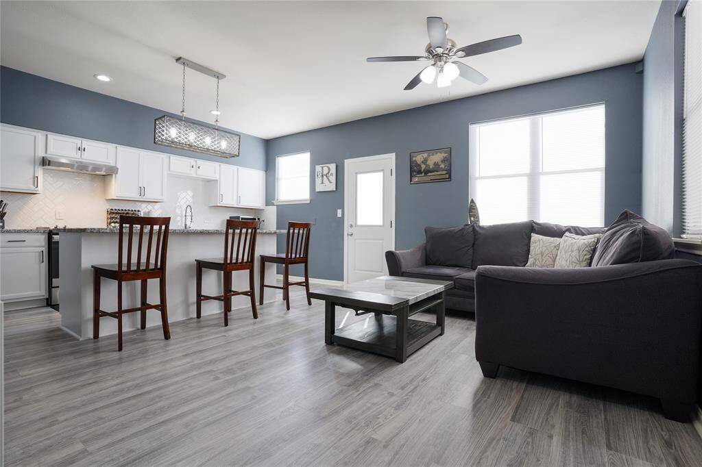 Unit B - Laminate flooring, ceiling fan, and large kitchen island.