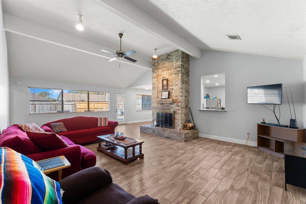 Spacious living room with tall ceilings. Lovely fireplace as the focal point.