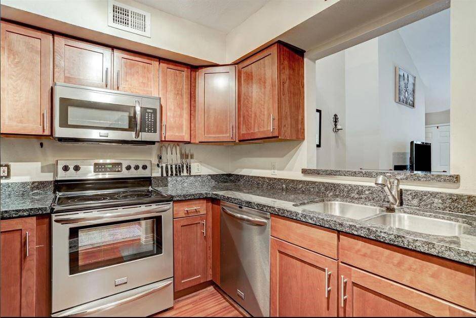 Kitchen with stainless steel appliances and granite countertop