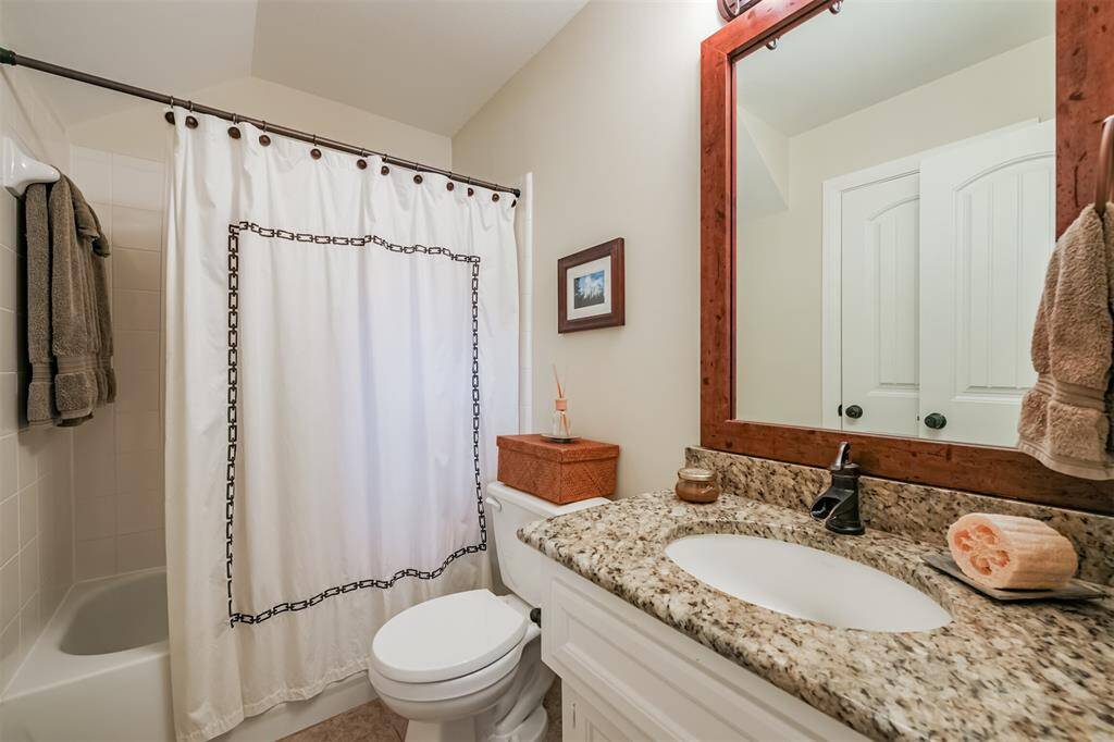 Secondary full bathroom has also been updated with granite counters, new sink and faucet and framed mirror.