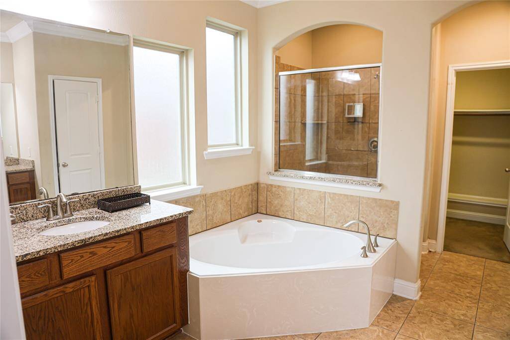 Primary bath view of her sink and a great saoking tub