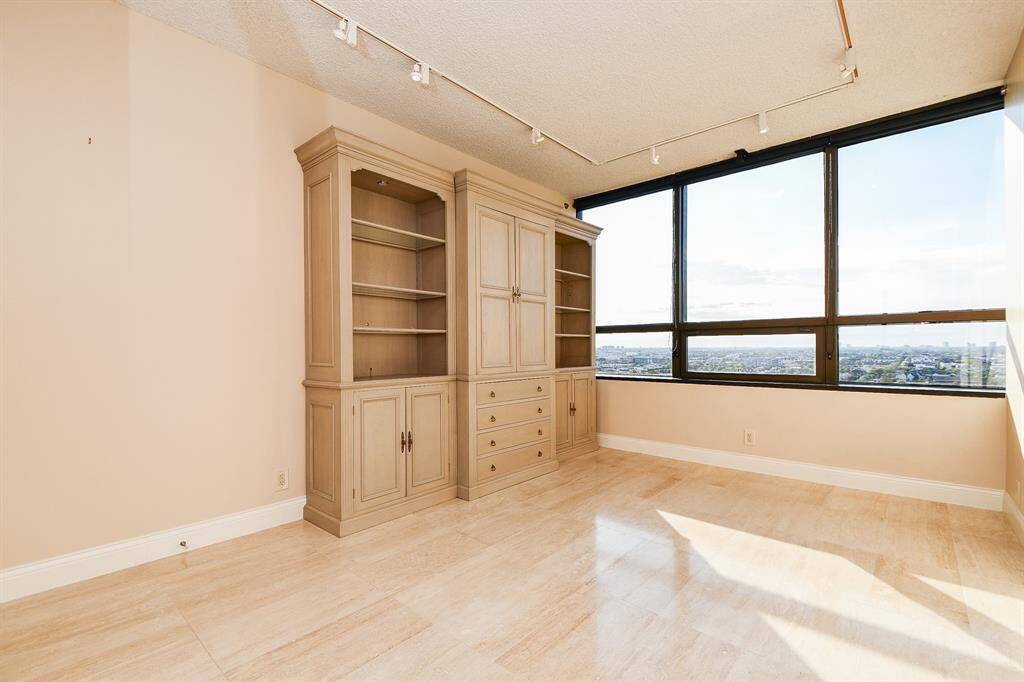 Second bedroom with storage bookshelves could be study
