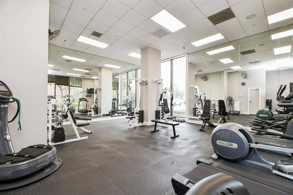 Fitness room has 1/2 bath & is light & bright